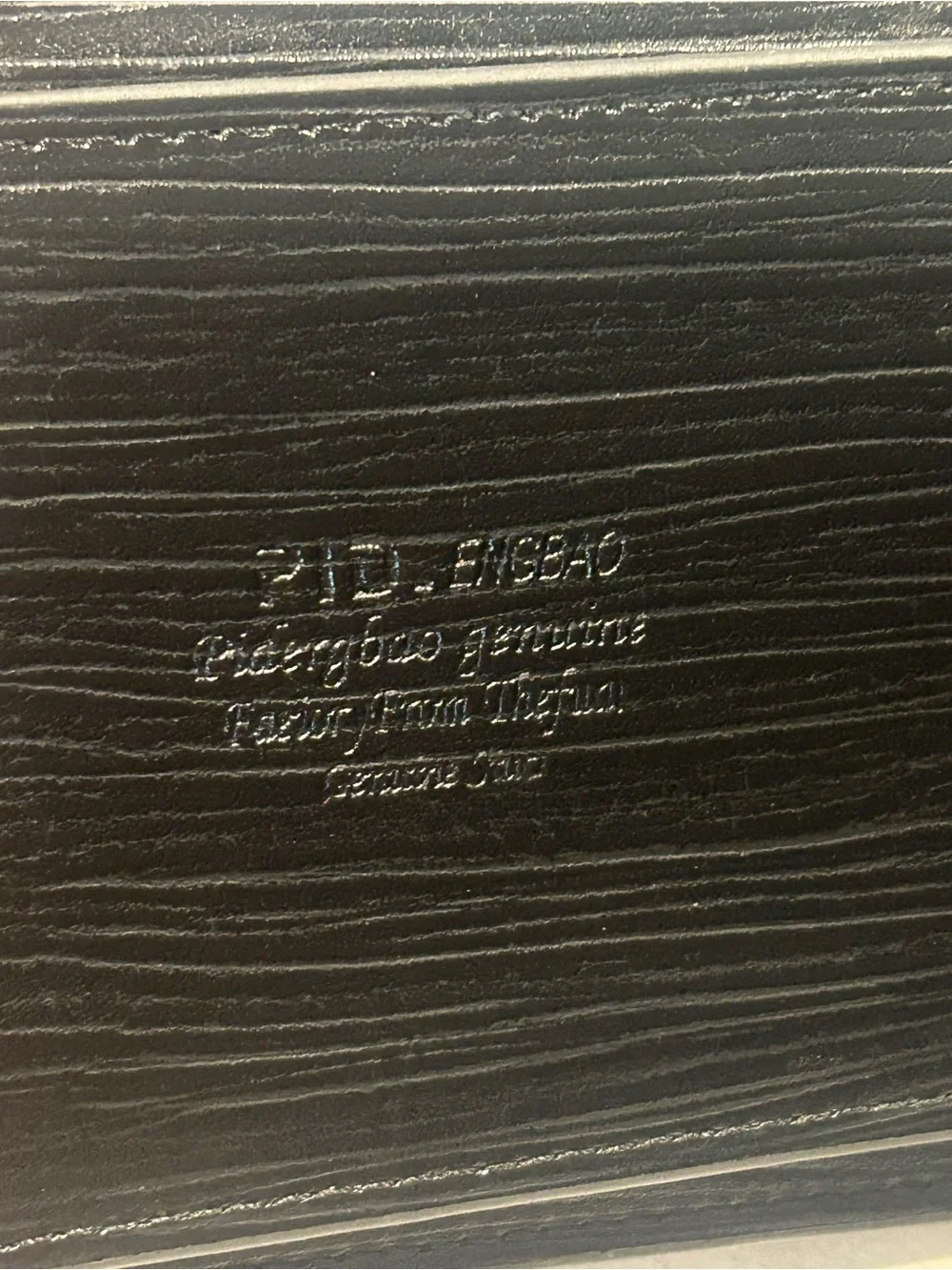Men's Black Leather Bi-Fold Wallet with Embossed Face and Yellow Eye Accent